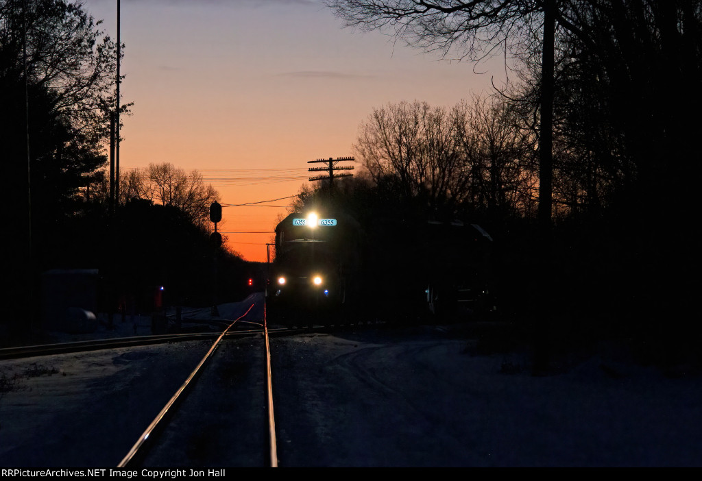 With the glow of sunrise in the eastern sky, Z127 comes north across CN's Holly Sub